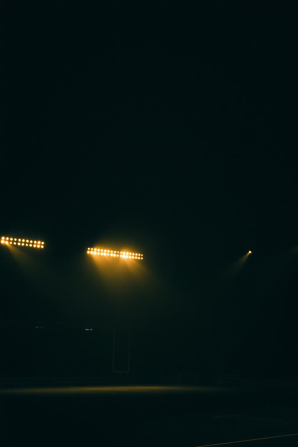 Floodlights over a night rugby stadium